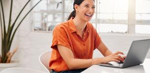 Image of a woman working at a laptop.