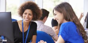 Image of a young woman with a careers adviser looking at a computer screen.