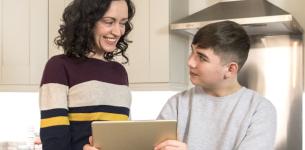 Picture of mother and son looking at a tablet device