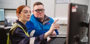 Higher Level Apprenticeships: Photograph of a woman and a man examining the contents of a TV screen in an industrial setting.