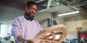 Types of Apprenticeships: Photograph of a man examining a piece of woodwork.