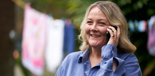 Lady talking on Mobile telephone, washing line in background