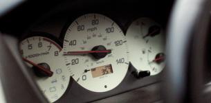 A speedometer of a car showing it is doing 30 miles per hour