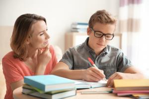 Mother helping son do homework