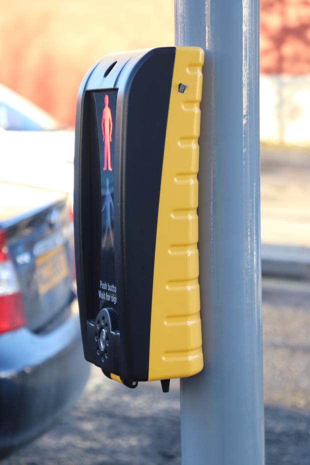 Photo of a pedestrian crossing signal with a tactile device or 'rotating cone'