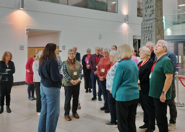 PRONI staff member delivering a tour to a group of individuals in the PRONI foyer