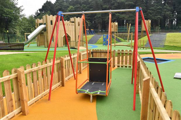 Photo of swing that can hold a wheelchair at the children's play park at Stormont Estate, Belfast Photo of swing that can hold a wheelchair at the children's play park at Stormont Estate, Belfast